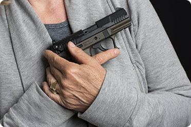 A woman holding a gun in her hand.