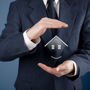 Businessman in suit holding house icon - Alex Kincaid Law
