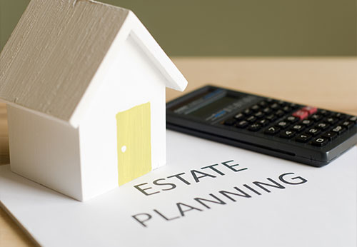 A small house model and calculator on an 